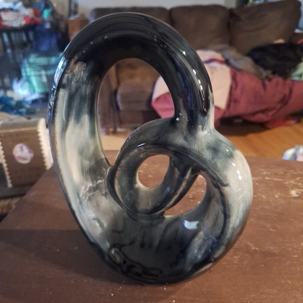 mid-century biomorphic glazed ceramic sculpture with swirling design.